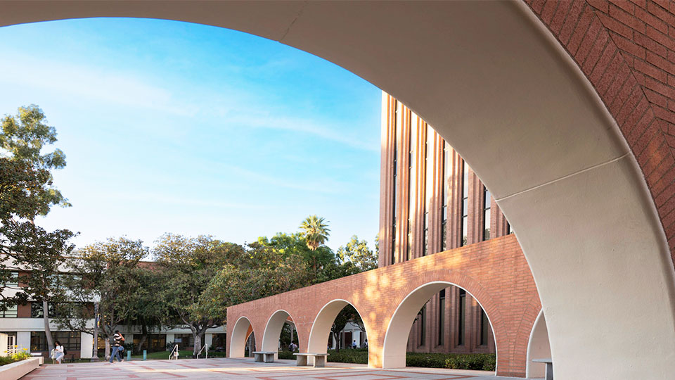 Arched buildings near the Barbara and Roger Rossier School of Education